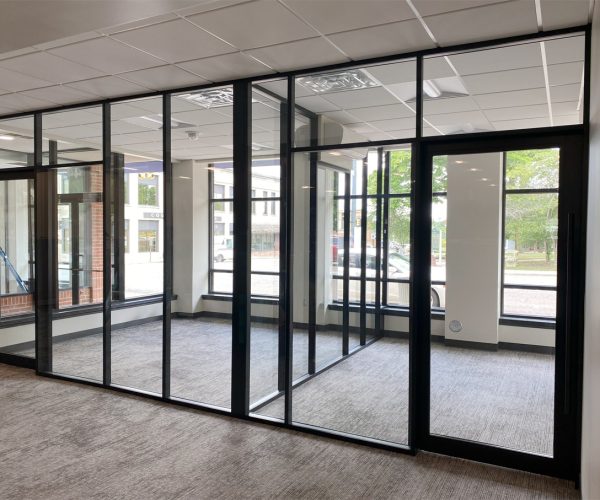 Glass-offices-with-glass-sidewalls-and-black-frame-color-field-fit-demountable-walls